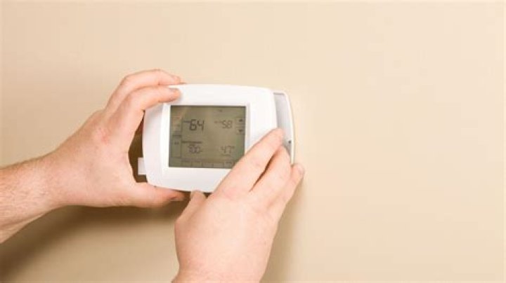 How do I change the thermostat in my Frigidaire freezer