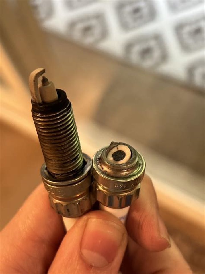 How do you get a broken spark plug out