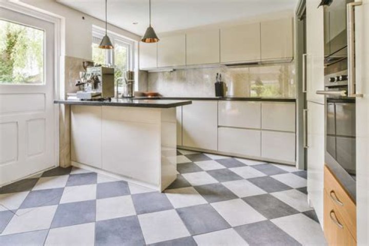 How do you tile a kitchen floor over linoleum