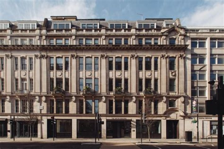 What phrase appears on the posters in Winston Smiths building