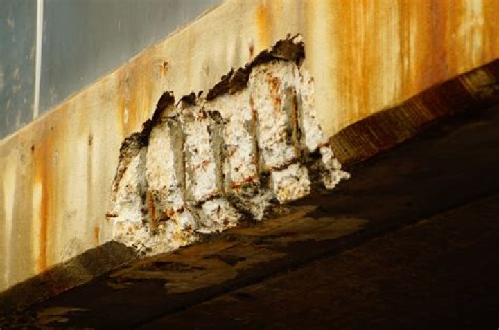 What prevents corrosion of steel on concrete