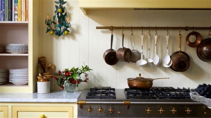 Where should pots and pans be stored in the kitchen