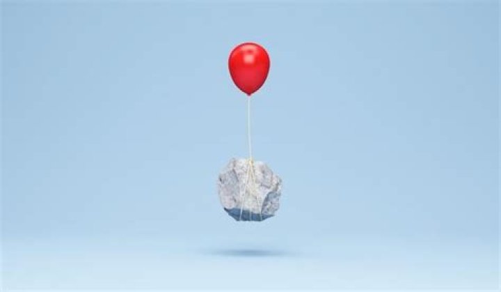 Why does a balloon with air weigh more than an empty balloon