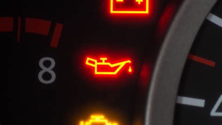 Why is it important to pull over when the oil pressure warning light comes on