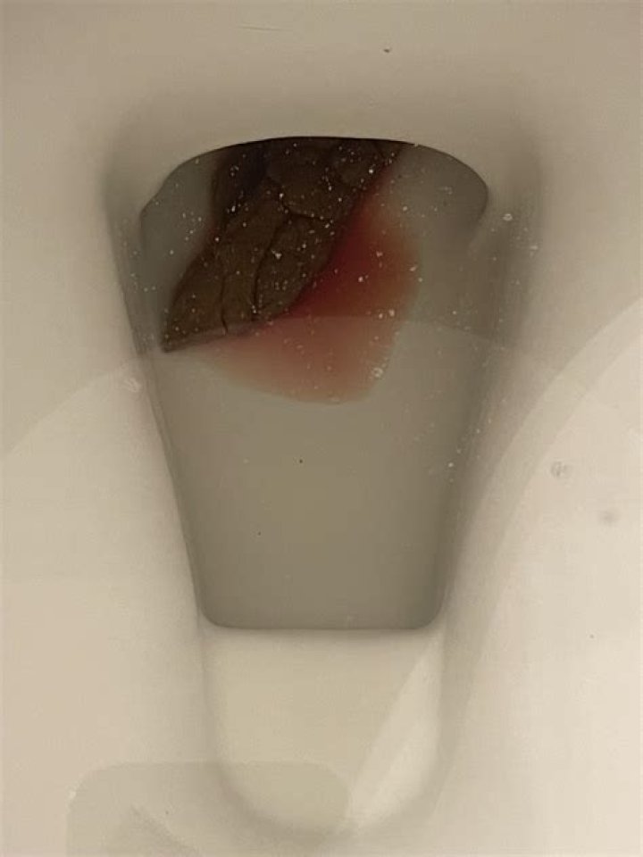 Why is there red residue in my toilet